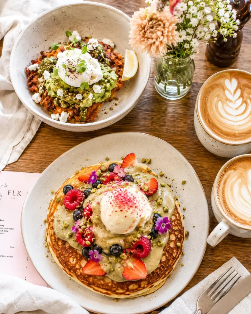 Branch in Sunbury at The Spotted Owl Cafe — hotcakes, fritters and specialty coffee on a timber table
